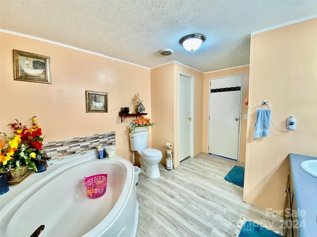 bathroom with vanity, a textured ceiling, toilet, a tub, and hardwood / wood-style floors