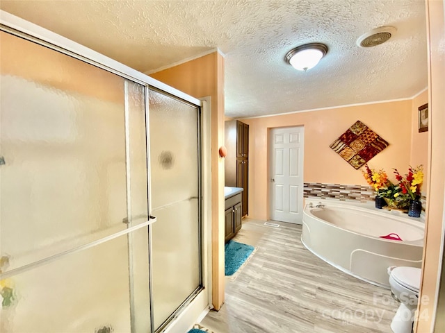 full bathroom featuring independent shower and bath, hardwood / wood-style flooring, vanity, and toilet