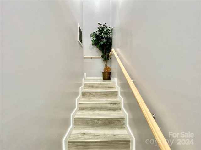 stairs featuring hardwood / wood-style flooring