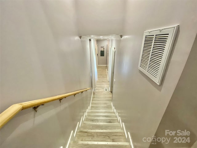 stairs featuring wood-type flooring