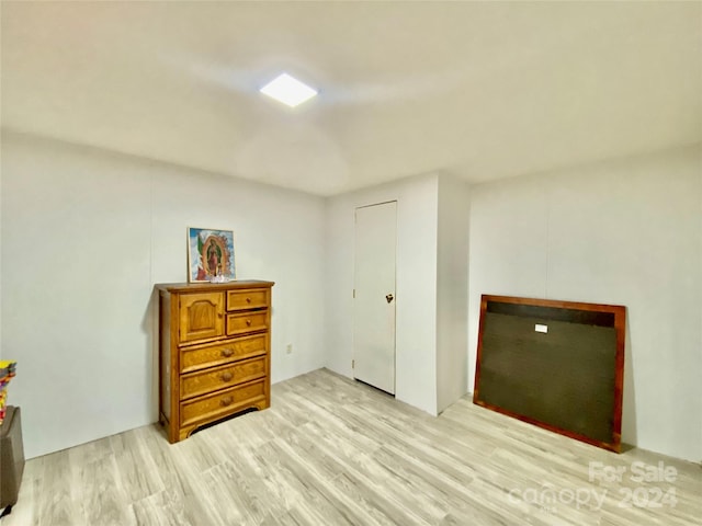 bedroom featuring light hardwood / wood-style flooring and a closet