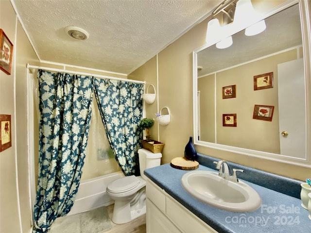 full bathroom featuring a textured ceiling, vanity, toilet, and shower / bath combination with curtain