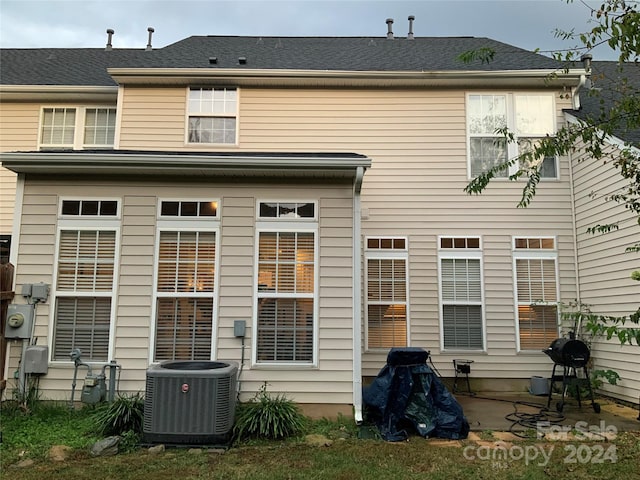 rear view of house with a patio and central AC unit