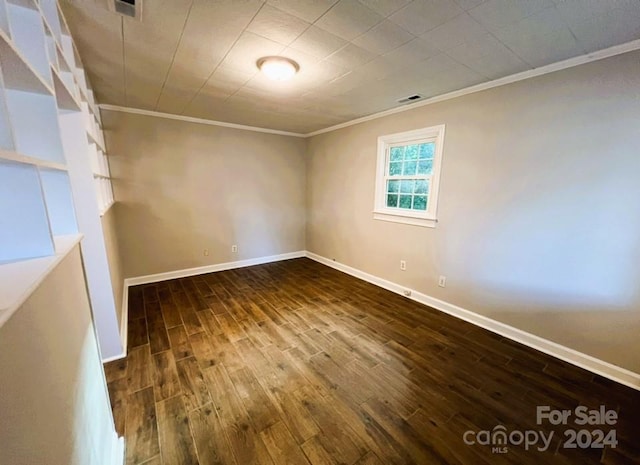 unfurnished room featuring ornamental molding and hardwood / wood-style flooring