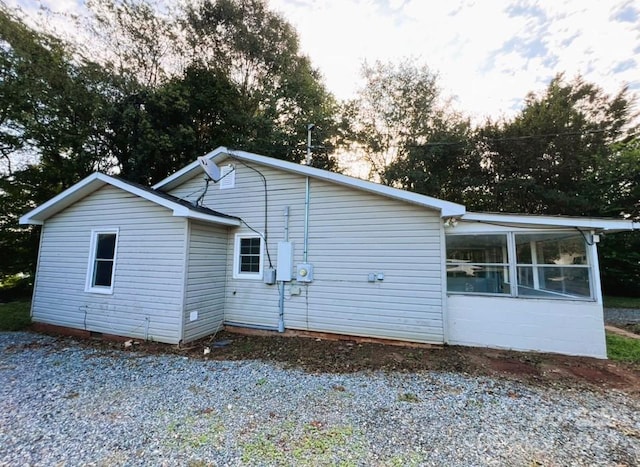 back of property with a sunroom