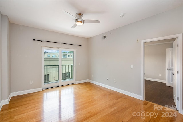 empty room featuring ceiling fan and hardwood / wood-style floors