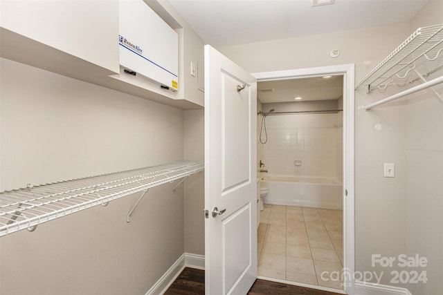 spacious closet featuring tile patterned flooring