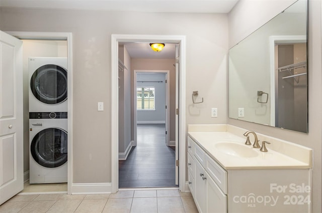 bathroom with stacked washer / drying machine, vanity, and hardwood / wood-style floors