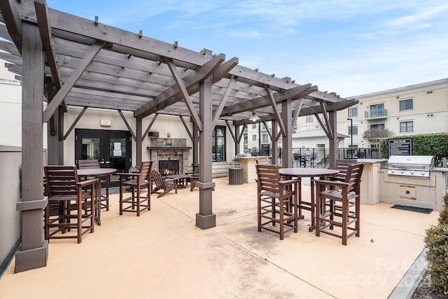 view of patio featuring grilling area, a pergola, area for grilling, and an outdoor fireplace