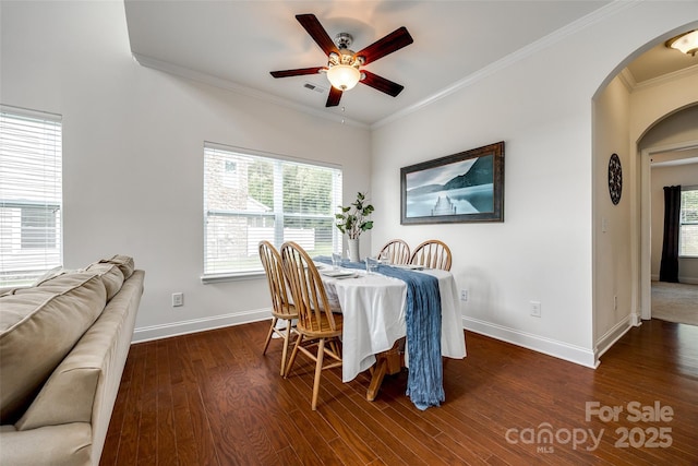 dining space with crown molding, dark hardwood / wood-style floors, and ceiling fan