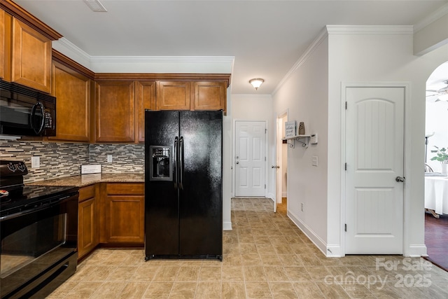 kitchen with black appliances, dark stone countertops, ornamental molding, ceiling fan, and backsplash