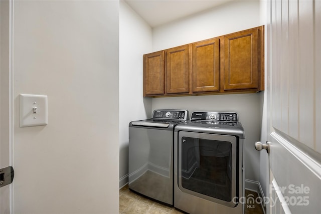 washroom featuring cabinets and independent washer and dryer