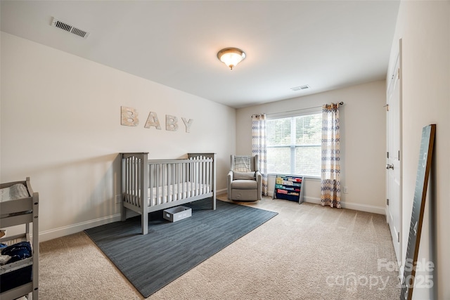 carpeted bedroom featuring a crib