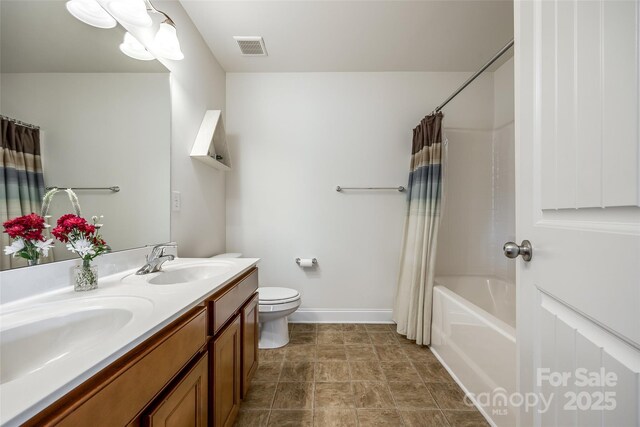 full bathroom featuring vanity, shower / tub combo, and toilet