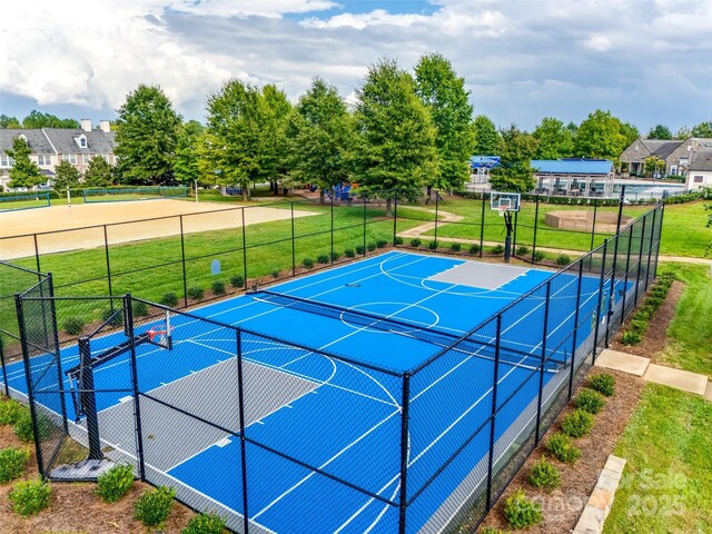 view of basketball court with a lawn