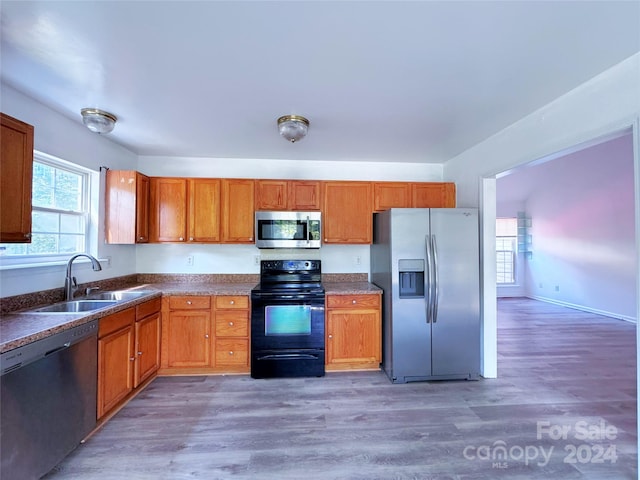 kitchen featuring appliances with stainless steel finishes, dark hardwood / wood-style floors, and sink