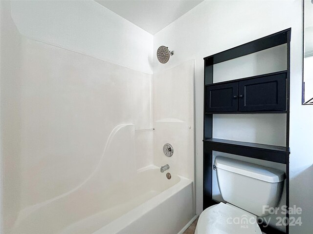 bathroom featuring toilet and shower / washtub combination