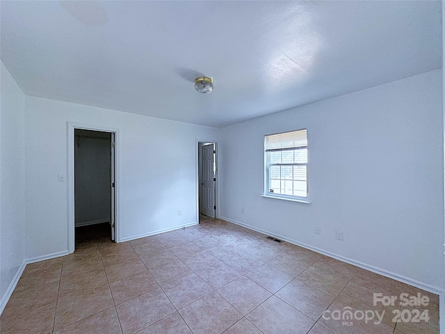 spare room with light tile patterned floors