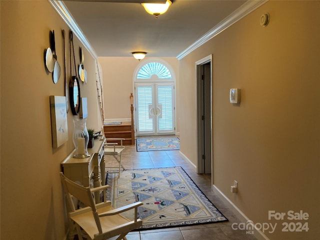 doorway to outside with light tile patterned floors and crown molding