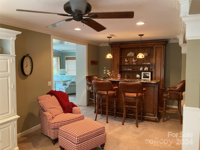 bar featuring hanging light fixtures, ornamental molding, ceiling fan, and light carpet