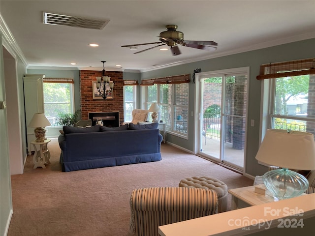 carpeted living room featuring ornamental molding, a wealth of natural light, and a brick fireplace