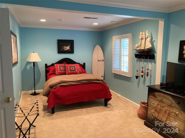 bedroom with crown molding and carpet