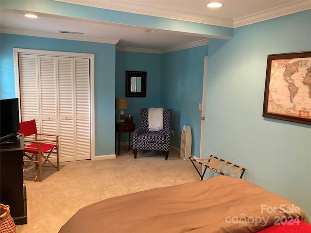 bedroom featuring ornamental molding, a closet, and light colored carpet