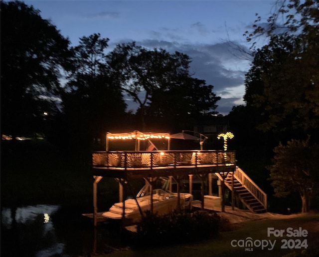 back house at dusk with a deck