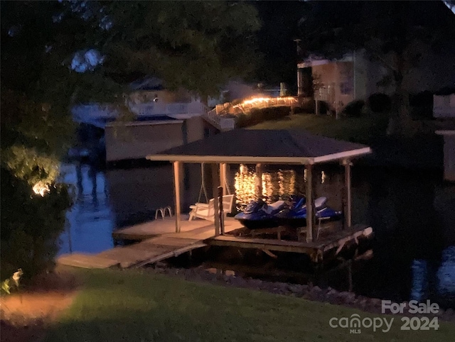 dock area with a lawn and an outdoor fire pit