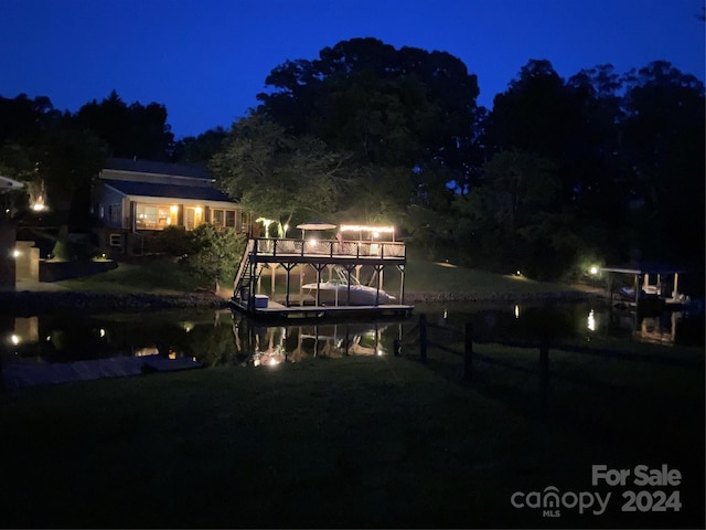 back house at twilight featuring a yard