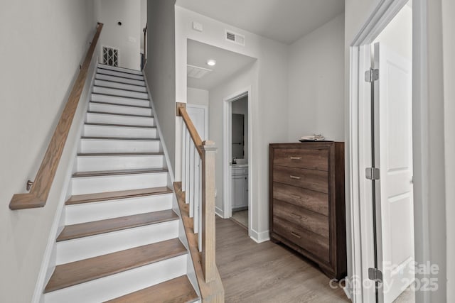 stairs with hardwood / wood-style flooring