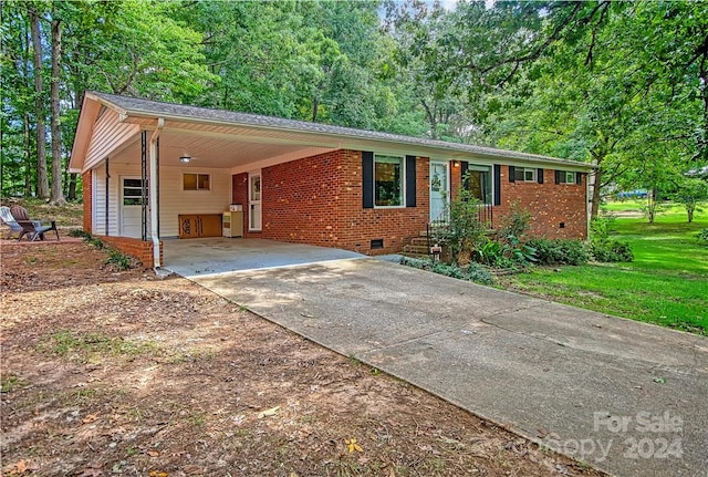 ranch-style house with a front yard and a carport