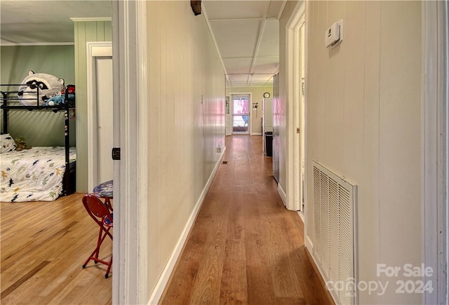 corridor featuring wood walls and hardwood / wood-style flooring