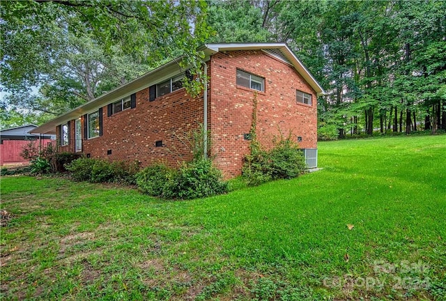 view of home's exterior with a lawn and central air condition unit