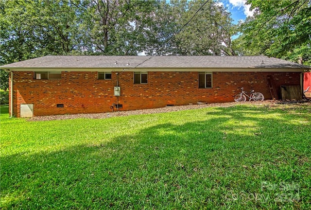 rear view of property with a yard