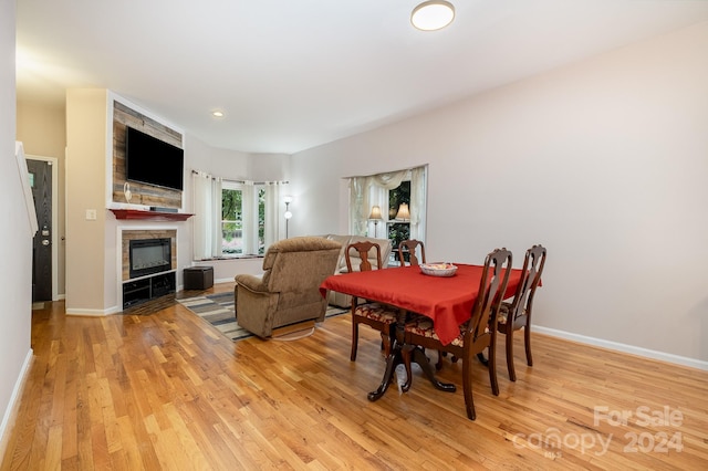 dining area featuring light hardwood / wood-style flooring and a fireplace