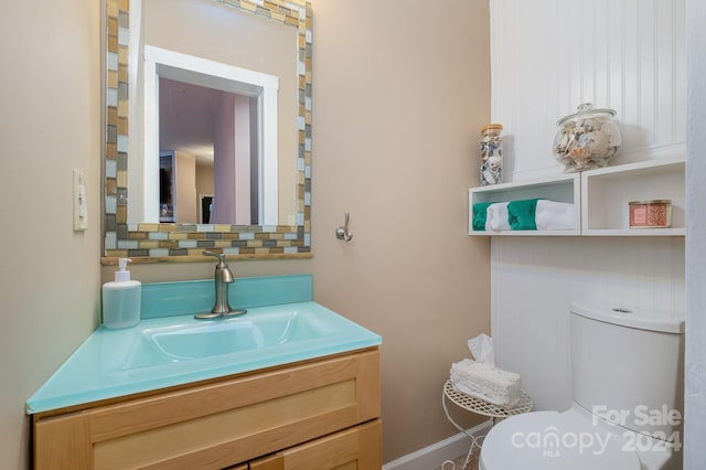 bathroom featuring vanity and toilet