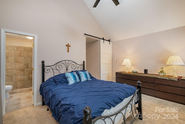 carpeted bedroom featuring a barn door, ensuite bath, ceiling fan, and high vaulted ceiling