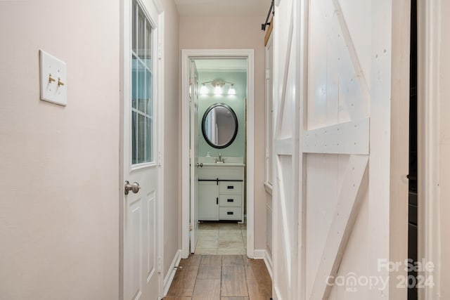 hall featuring sink and hardwood / wood-style floors