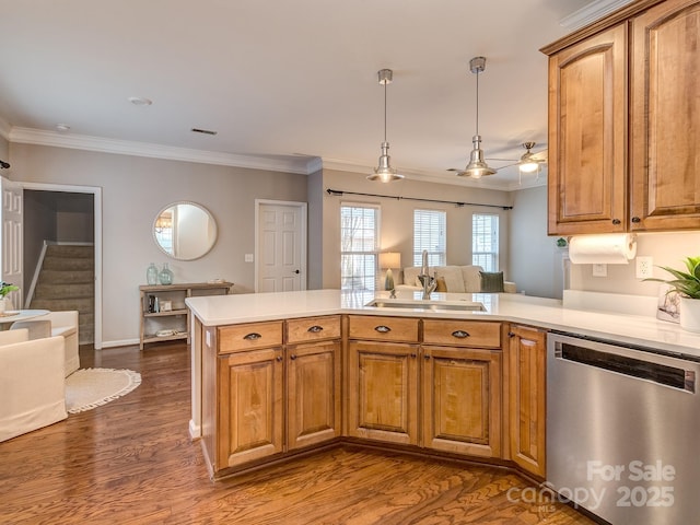 kitchen featuring dark wood-type flooring, sink, hanging light fixtures, stainless steel dishwasher, and kitchen peninsula