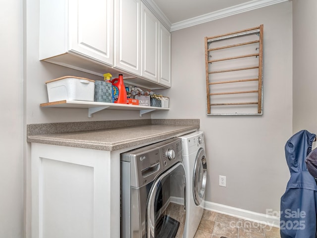 clothes washing area with crown molding, cabinets, and washing machine and dryer