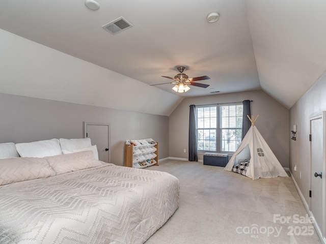 bedroom with vaulted ceiling, light colored carpet, and ceiling fan