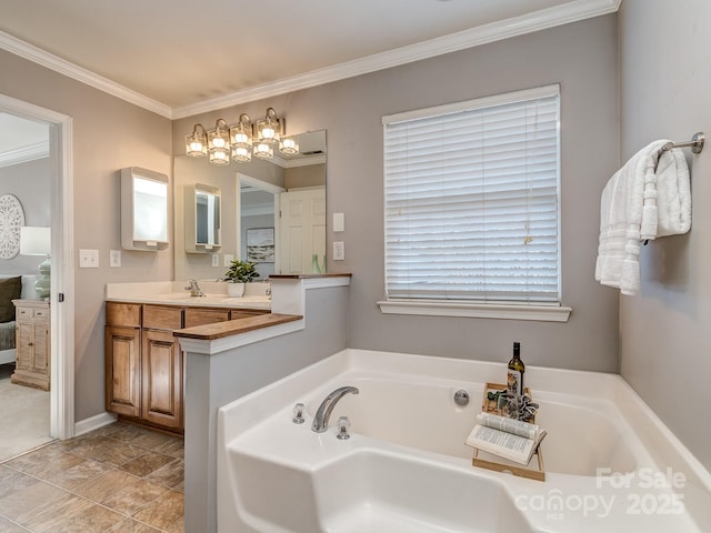 bathroom featuring vanity, ornamental molding, and a bathing tub