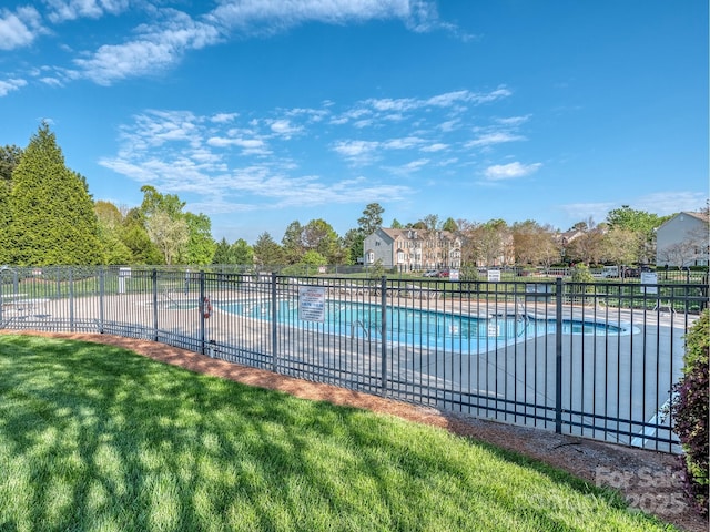 view of swimming pool featuring a patio area and a lawn