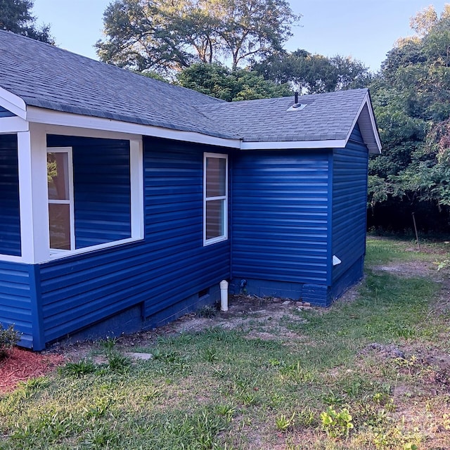 view of property exterior with a lawn