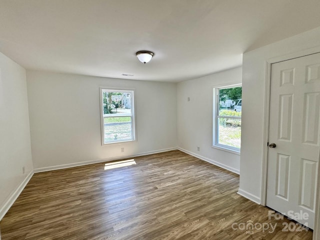 spare room with plenty of natural light and hardwood / wood-style floors