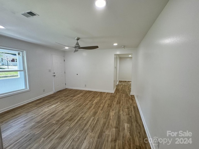 spare room featuring wood-type flooring and ceiling fan