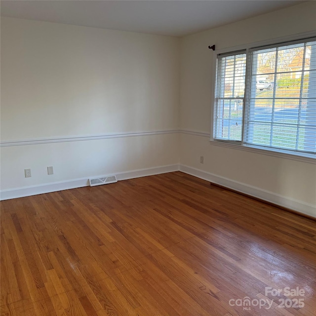 spare room with wood-type flooring