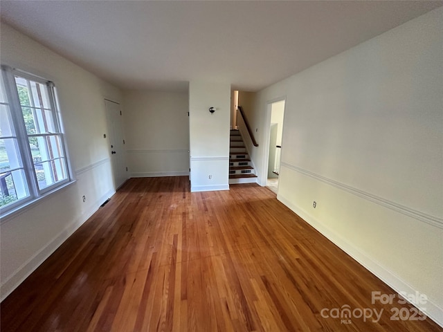 unfurnished room with hardwood / wood-style flooring