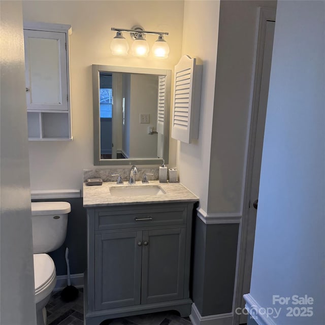 bathroom featuring vanity and toilet